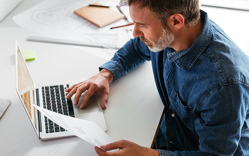 A man researching how to get an emergency loan